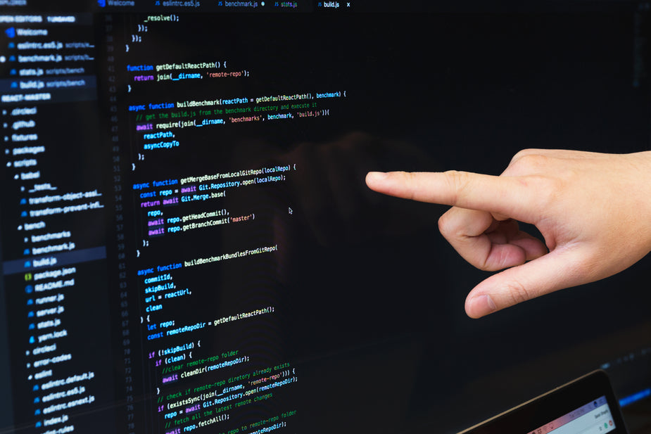 A Developer points to the Javascript code in their IDE.