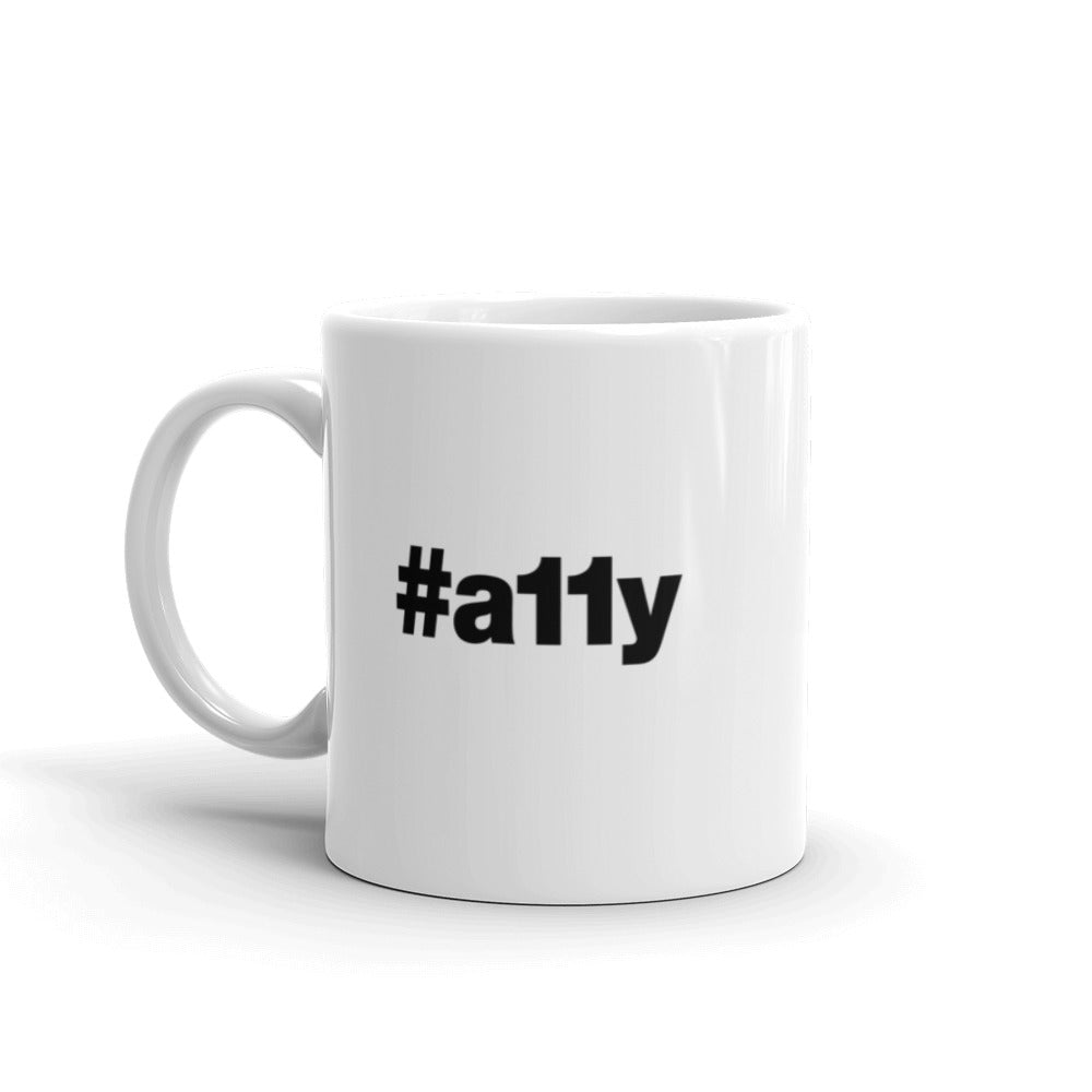 Black, #a11y letters on left and right side of white coffee mug.