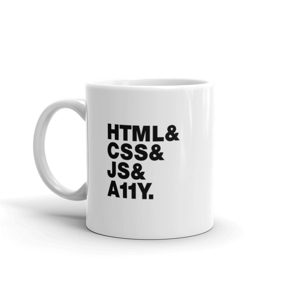 Black, HTML & CSS & JS & A11Y words on left and right side of white coffee mug.