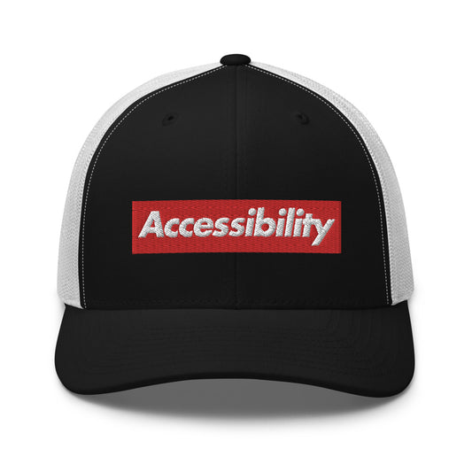 White, bold, slightly italic Accessibility word on red background, on black trucker hat with white mesh backing.