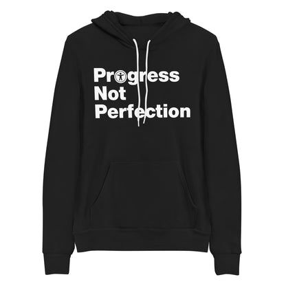 White, Progress Not Perfection, words, stacked, left aligned. 'O' in Progress is round universal icon, on front of black hooded sweater.