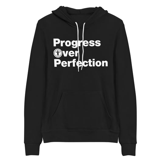 White, Progress Over Perfection, words, stacked, left aligned. 'O' in Over is round universal icon, on front of black hooded sweater.