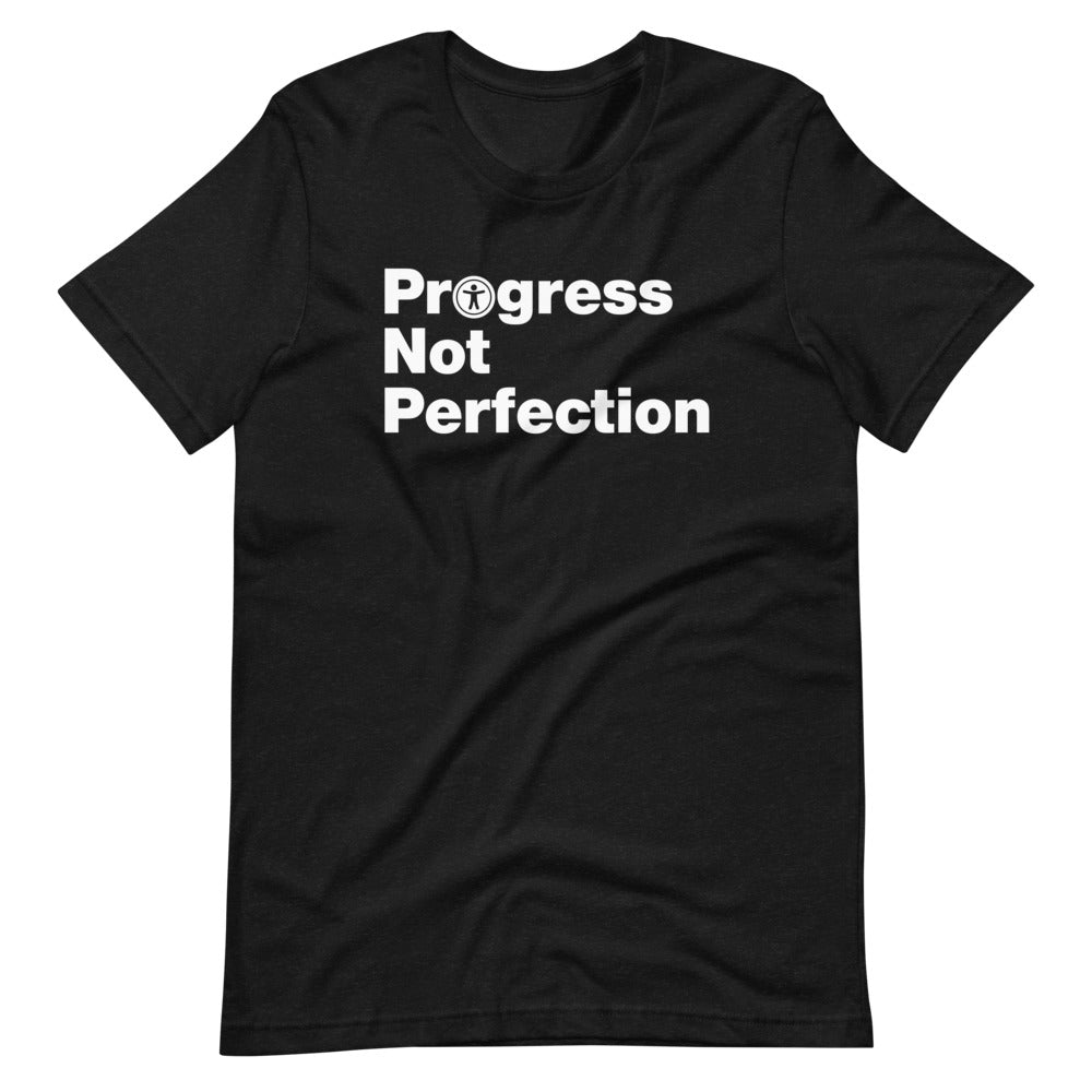 White, Progress Not Perfection, words, stacked, left aligned. 'O' in Progress is round universal icon, on front of heather black t-shirt.