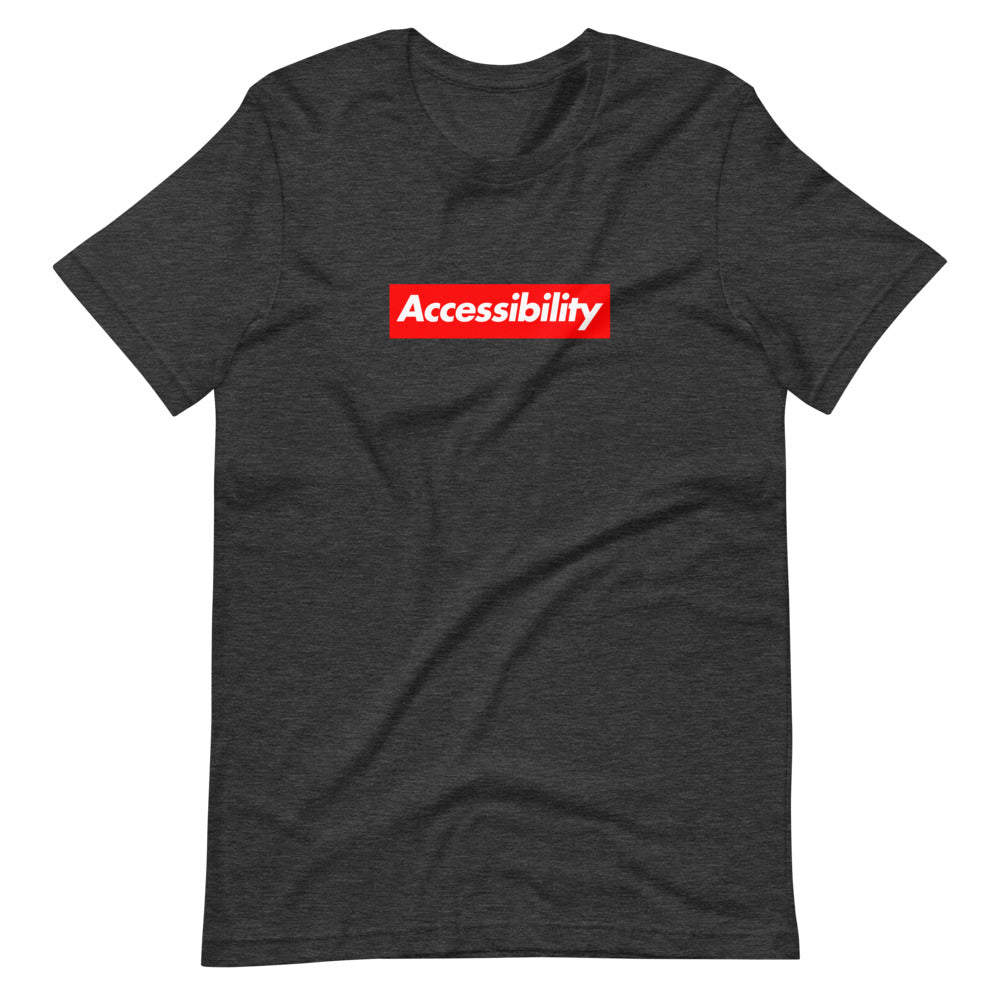 White, bold, slightly italic Accessibility word on red background, on dark heather grey t-shirt.