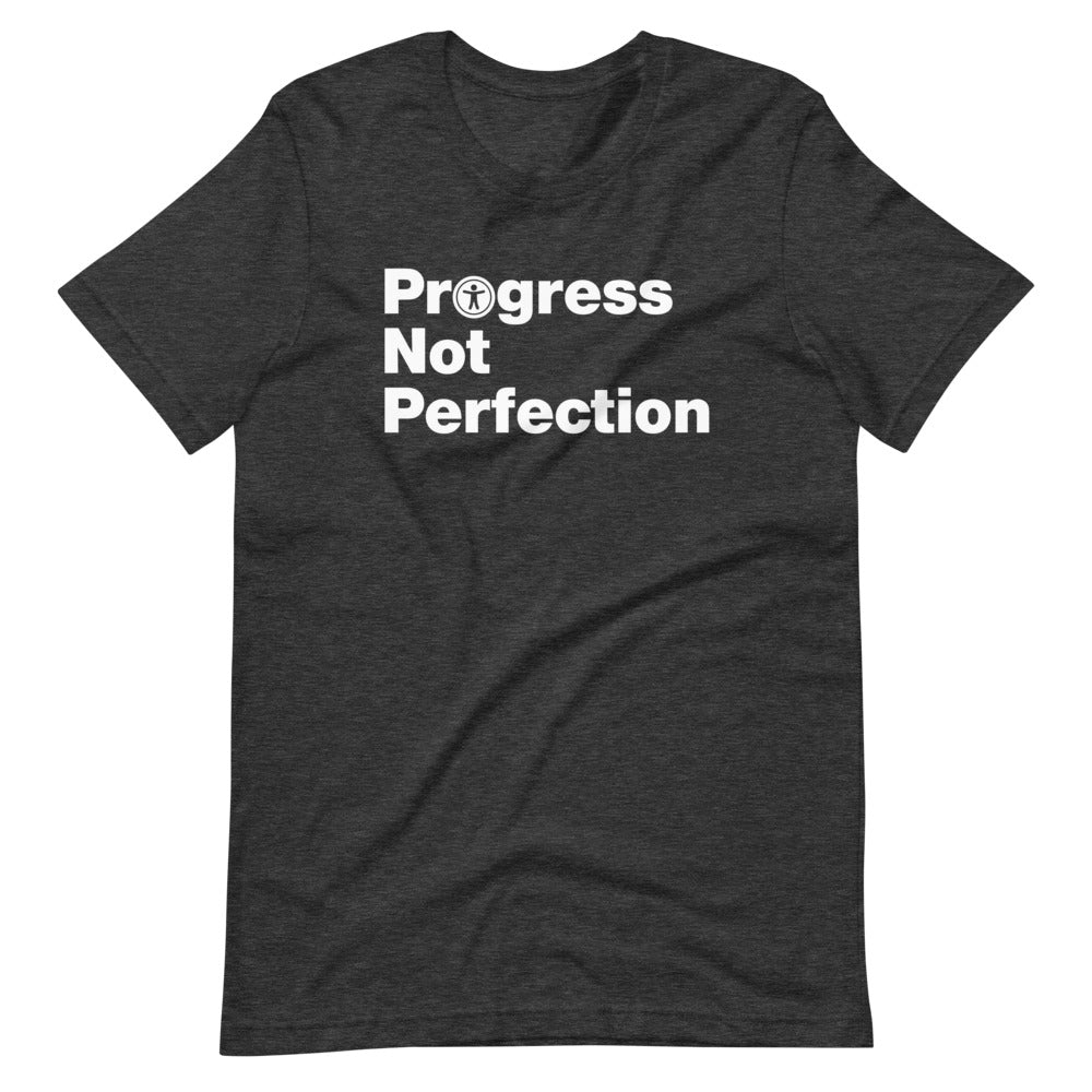 White, Progress Not Perfection, words, stacked, left aligned. 'O' in Progress is round universal icon, on front of dark heather grey t-shirt.