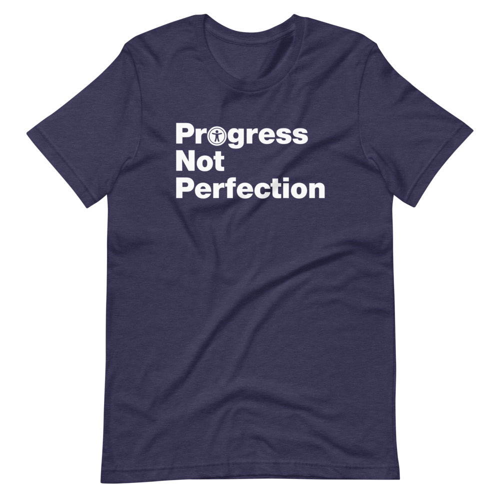 White, Progress Not Perfection, words, stacked, left aligned. 'O' in Progress is round universal icon, on front of heather navy blue t-shirt.