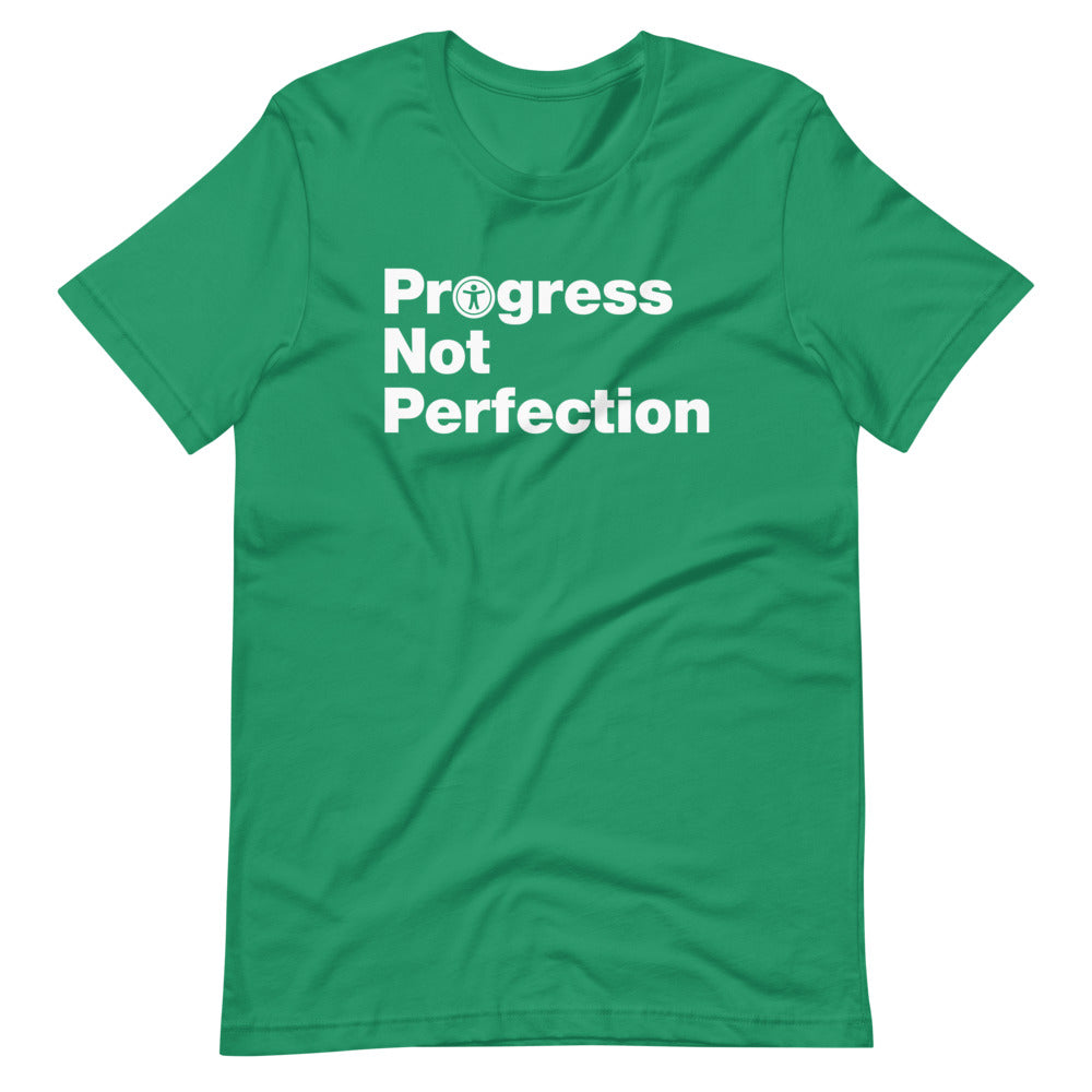 White, Progress Not Perfection, words, stacked, left aligned. 'O' in Progress is round universal icon, on front of kelly green t-shirt.