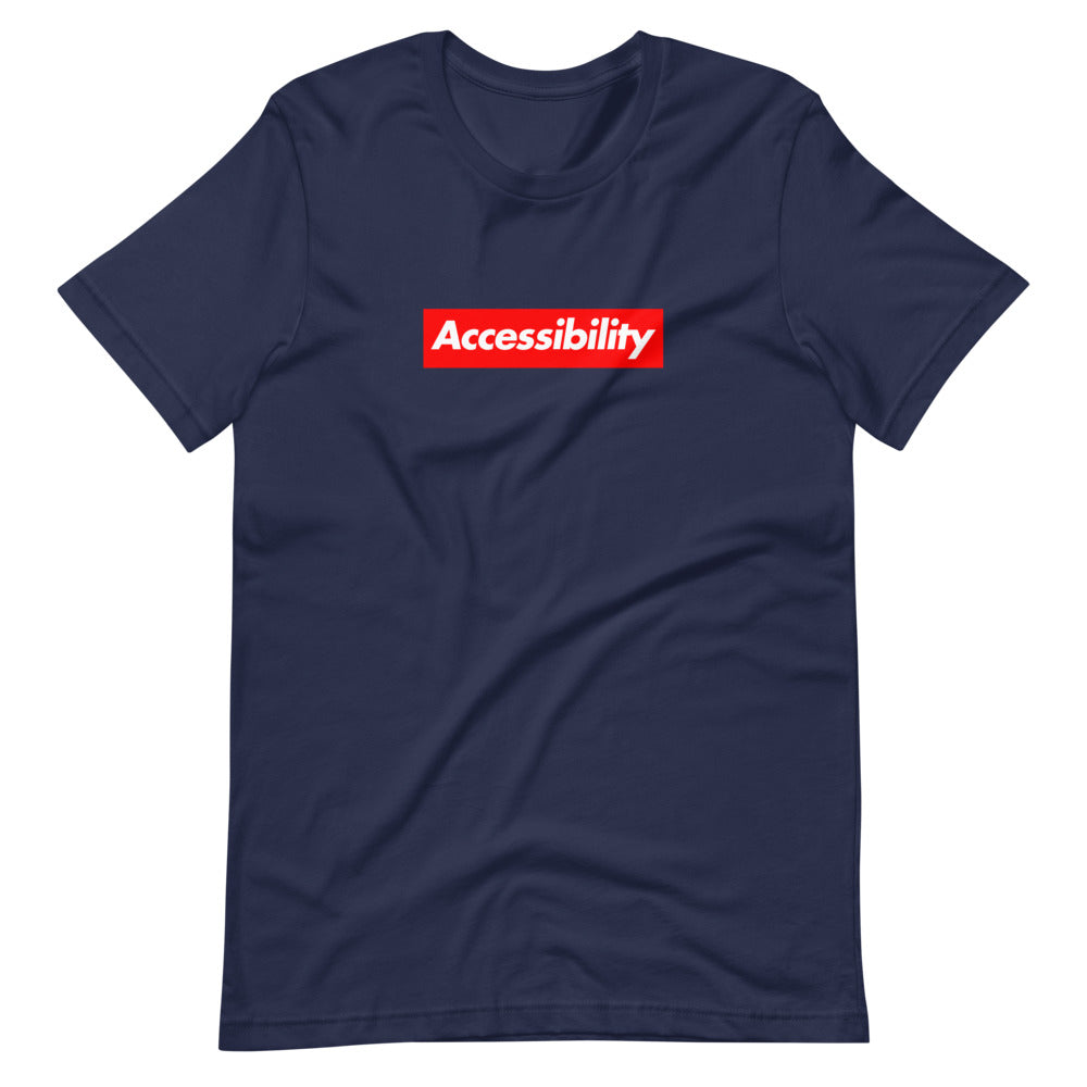 White, bold, slightly italic Accessibility word on red background, on navy blue t-shirt.