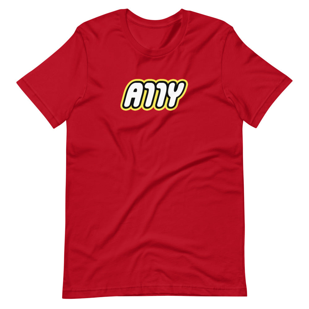 Rounded white A11Y letters surrounded by a black border, surrounded by a yellow border, center aligned on red t-shirt.