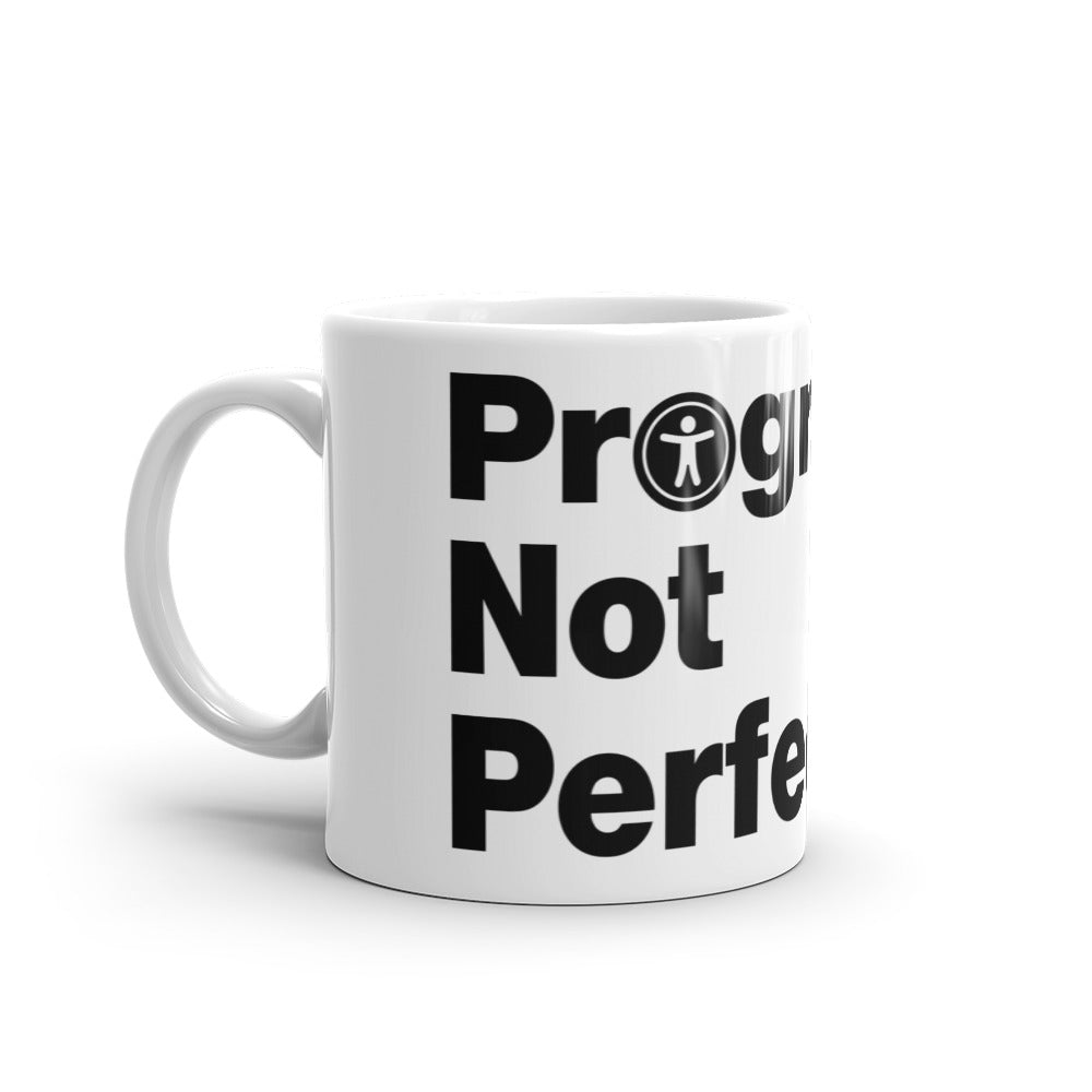 Black, Progress Not Perfection, words, stacked, left aligned. 'O' in Not is round universal icon, on front of white coffee mug, left side view.