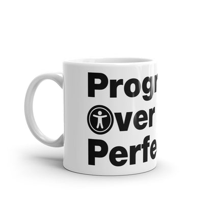 Black, Progress Over Perfection, words, stacked, left aligned. 'O' in Over is round universal icon, on front of white coffee mug, left side view.